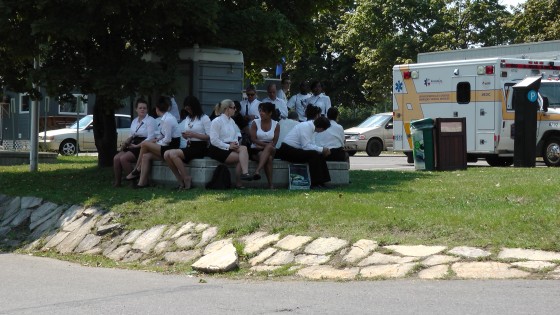 A bunch of waitresses waiting in the shade A nice place for a picnic at The Napa Auto Parts 200 presented by Dodge