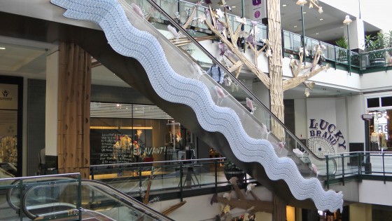 OMIGAWD!! Used water bottles stuck to the side of an escalator in a wavy pattern!!!
