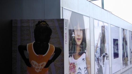 One of the portraits next to an advertisement for The Gap.