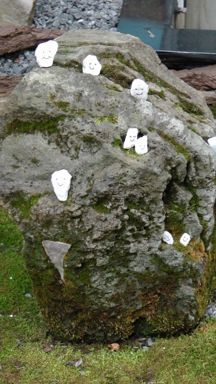 Some small happy rocks hanging out on a larger rock.