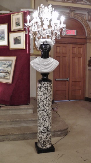 A "rare pair of Moor floor lamps. Glass and gilt metal chandeliers on glazed porcelain Moor busts on enameled metal pedestal. Milano, Italy circa 1960." Made by Piero Fornasetti.