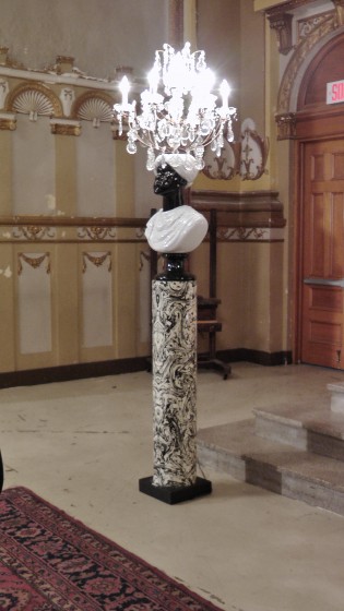 A "rare pair of Moor floor lamps. Glass and gilt metal chandeliers on glazed porcelain Moor busts on enameled metal pedestal. Milano, Italy circa 1960." Made by Piero Fornasetti.