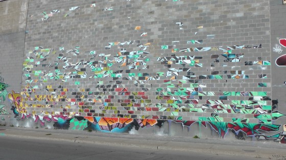 What happens when you do brick work on a wall with graffiti.