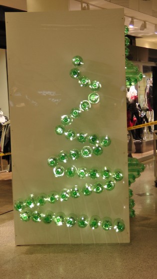 Something that I think is half of the shilouette of a Christmas tree made out of recycled soda bottles. Something that I think is half of the shilouette of a Christmas tree made out of recycled soda bottles.